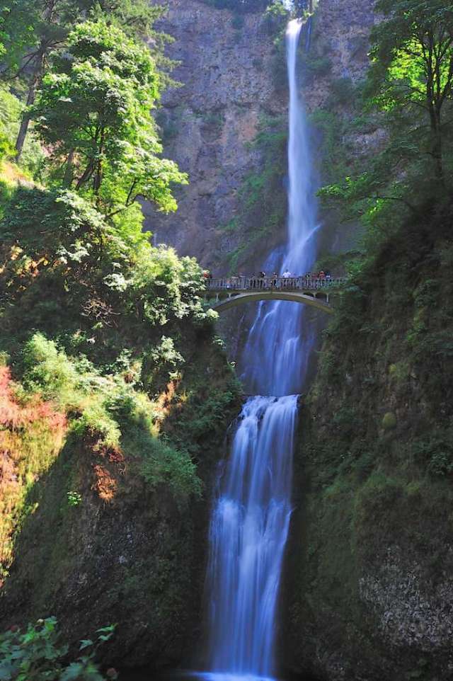 Mutnomah Falls, one of the tallest in Oregon. People on the walk bridge. Mutnomah Falls, one of the tallest in Oregon. People on the walk bridge.